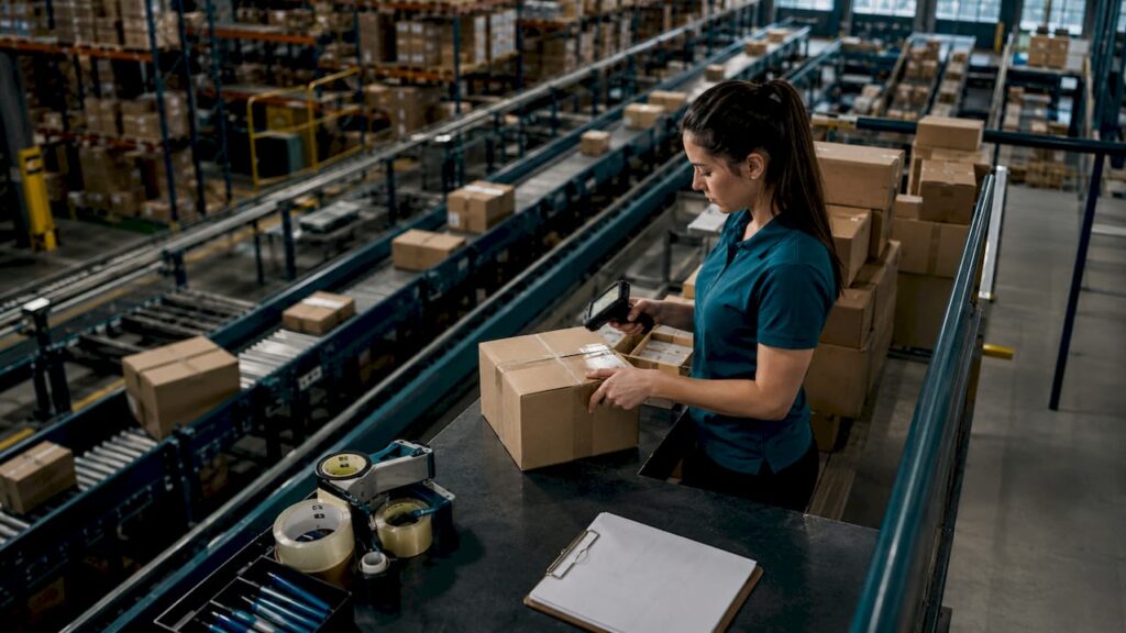 Warehouse worker scanning ecommerce packages