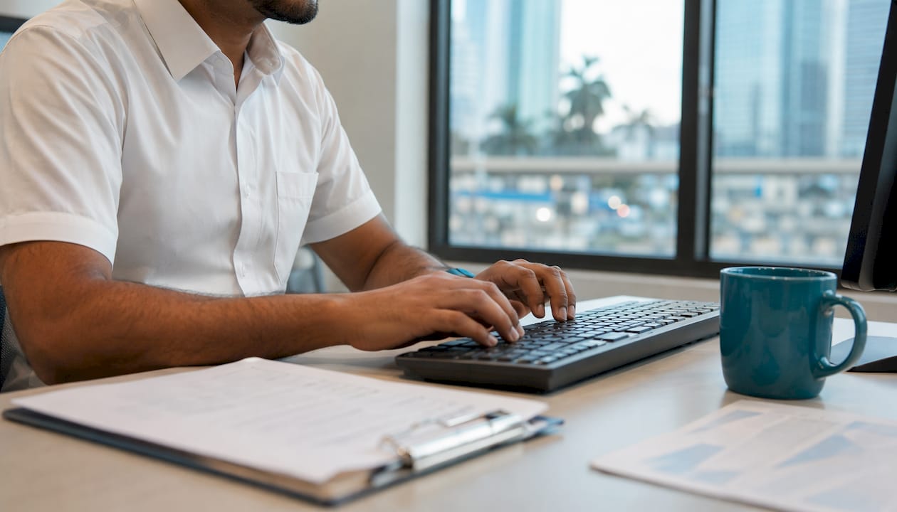 Hands typing on keyboard using logistics software