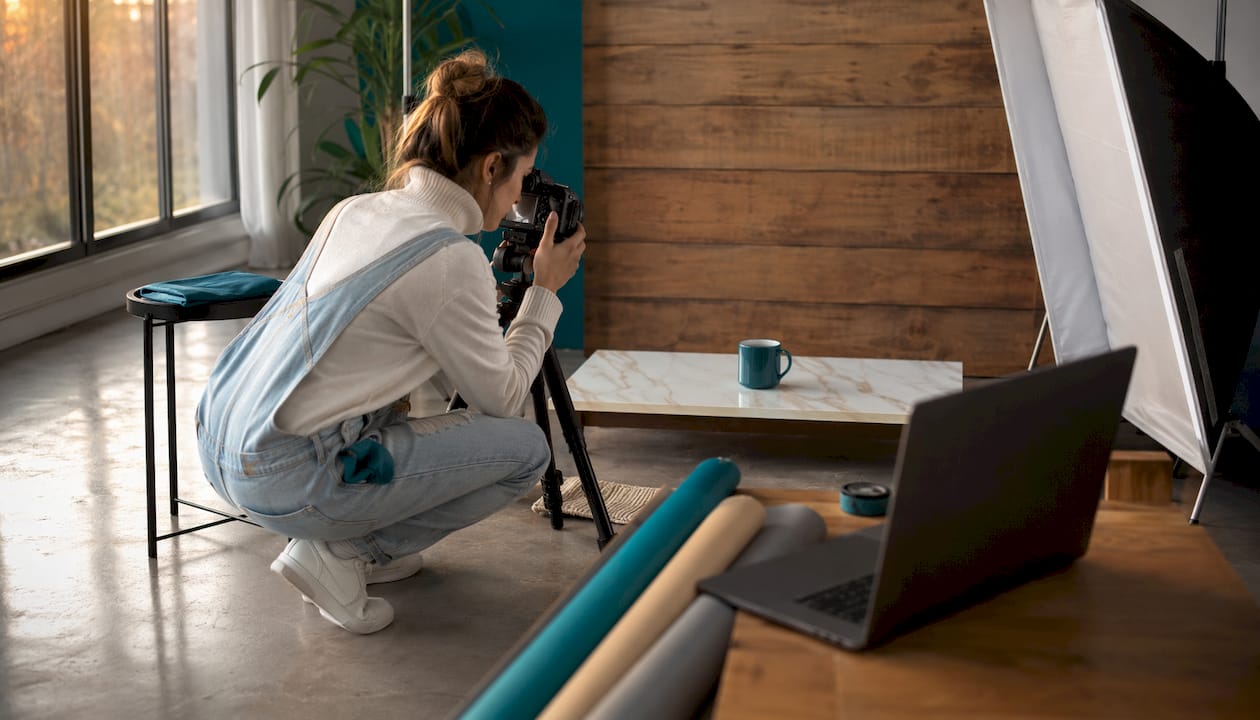 Photographer adjusting lights in product setup
