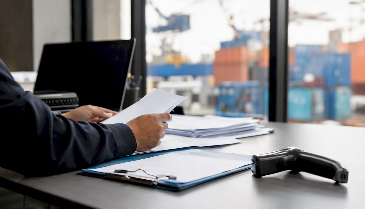 Hands sorting freight payment documents
