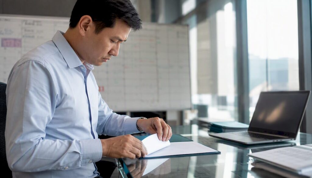 Hands placing bill of lading on desk