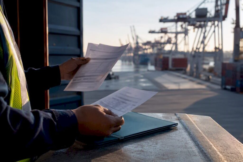 Auditor reviewing ocean freight charges at port